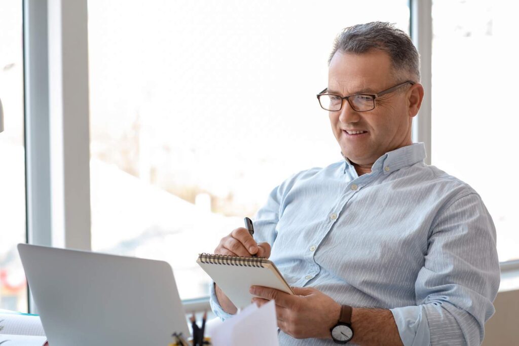 Mature man using laptop at home
