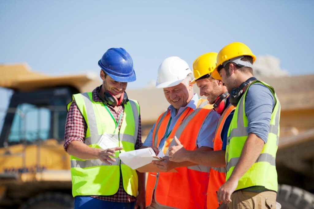 Workers and businessman talking in quarry