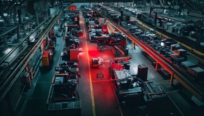 Industrial facility floor with production equipment, emphasizing the importance of spotting nonconformance through proactive safety monitoring.