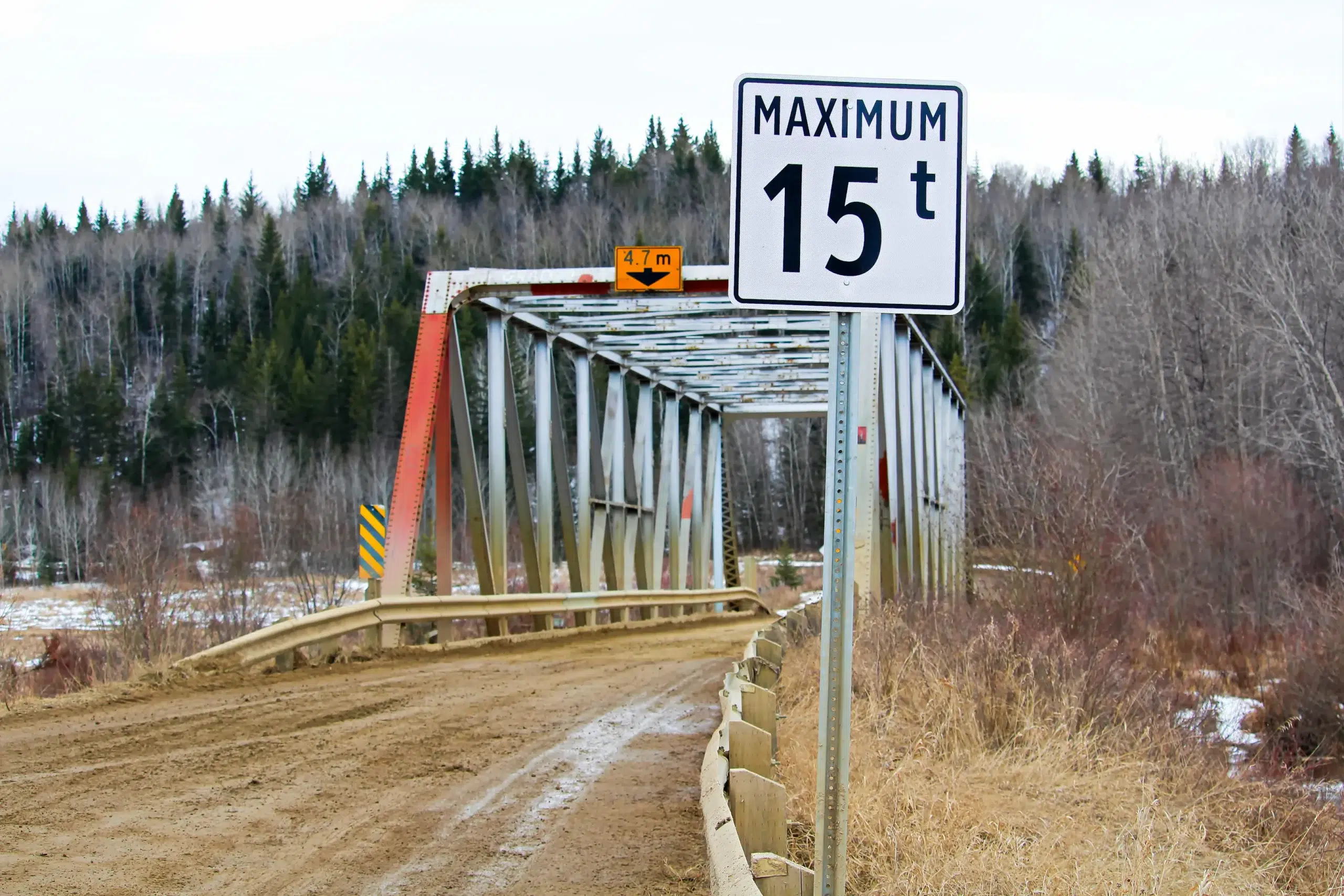 Bridge with posted height limit sign, highlighting the importance of vehicle dimension awareness.