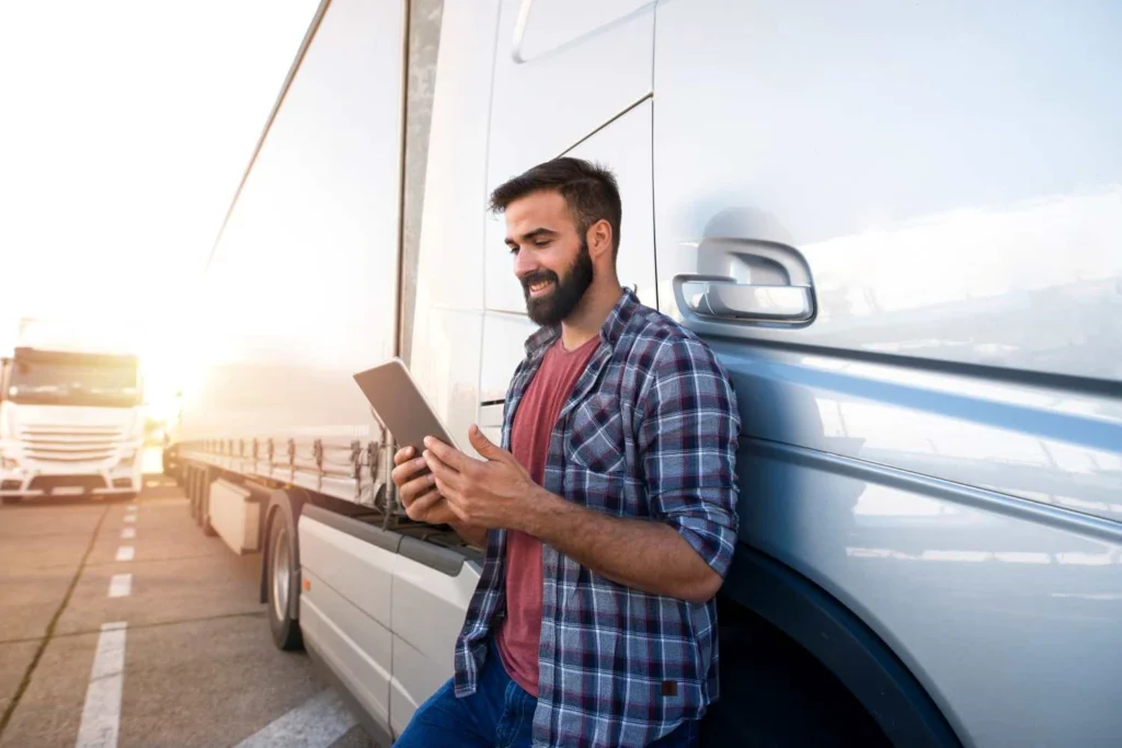 Man inspects truck for pre trip inspection on tablet