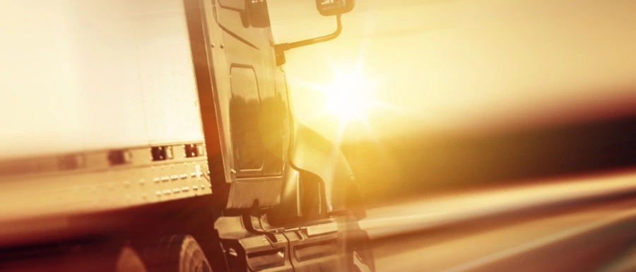 Sun setting on Semi Truck In Motion. Truck driving on the Highway after pre trip inspection form was filled out. 